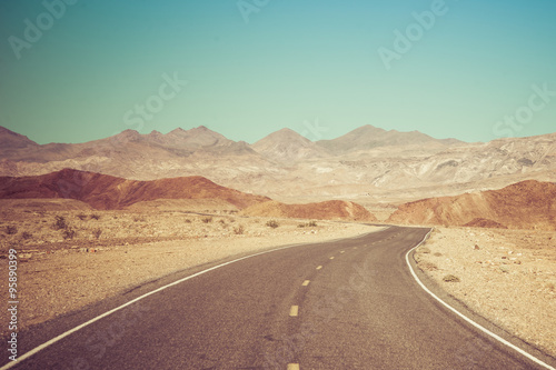 Open Road and possibilities. Road in Death Valley National Park. Artistic Instagram style processing