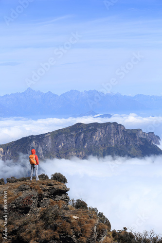  young woman hiker hiking on beautiful mountain peak