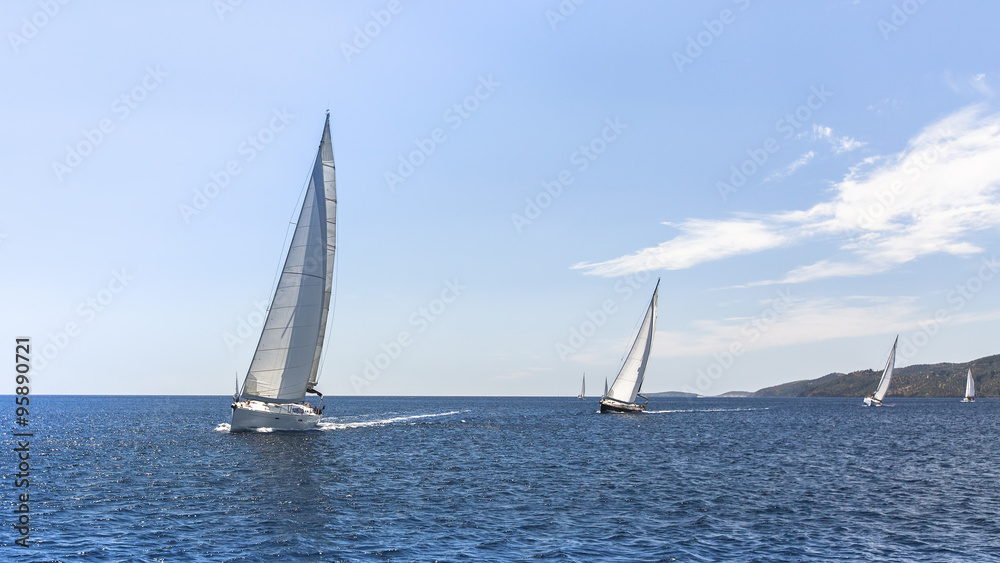 Sailing regatta. Sailing in the wind through the waves at the Aegean Sea in Greece.