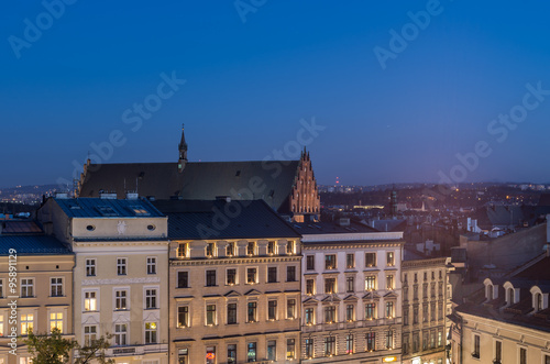 Holy Trinity church and building on the Main Market Square in the night seen from the Town Hall tower in Krakow, Poland