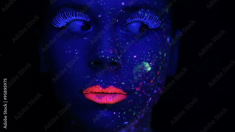 Woman face with fluorescent make up , creative makeup great for nightclubs , Halloween party, shows and music video Woman face with fluorescent make up , creative makeup great for nightclubs , Halloween party, shows and music video