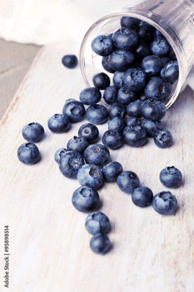 Fresh blueberries in glass on wooden table close up Fresh blueberries in glass on wooden table close up