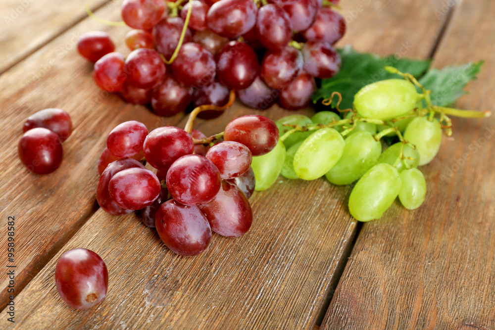 White and red grape on wooden background White and red grape on wooden background