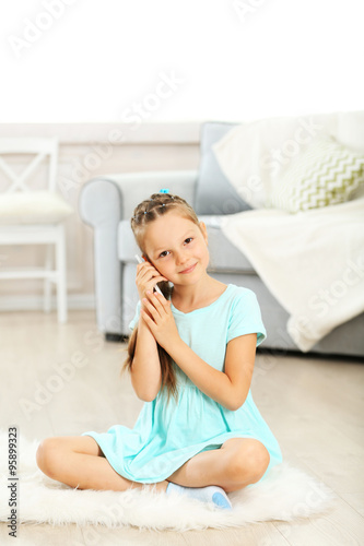 Little cute girl with mobil...