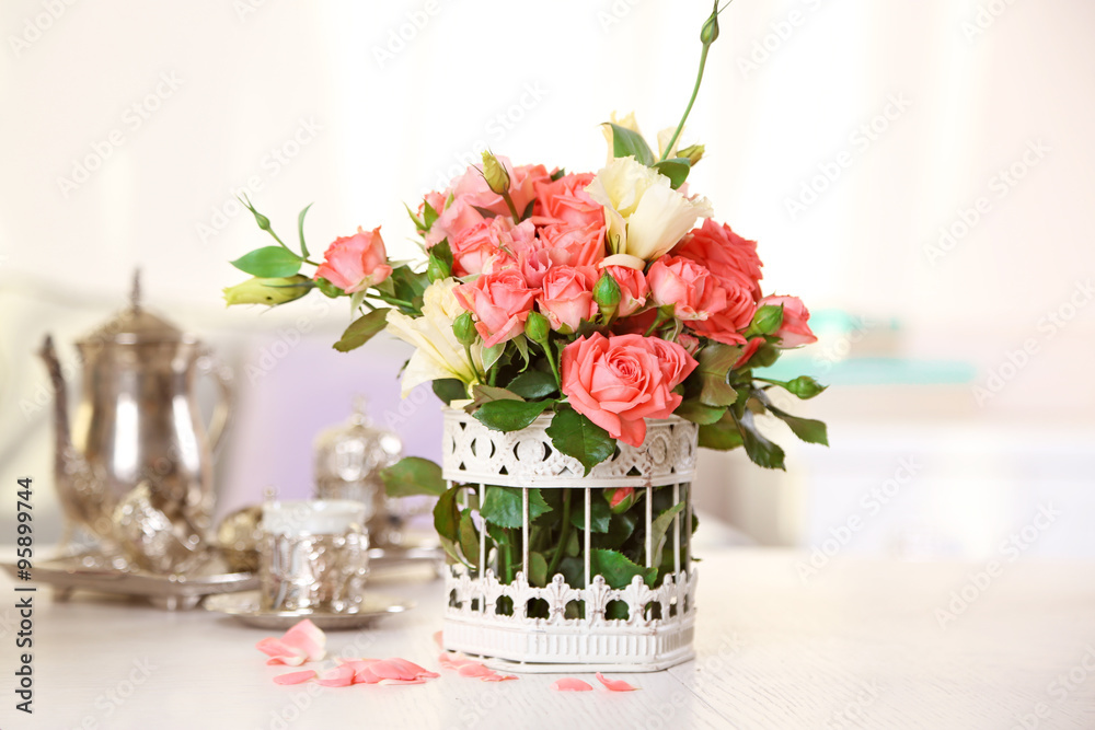 Obraz premium Beautiful rose in vase on table in room on bright background