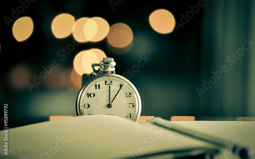 Pocket watch next to notebook. symbols of time