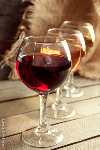 Composition of wine glasses on wooden background