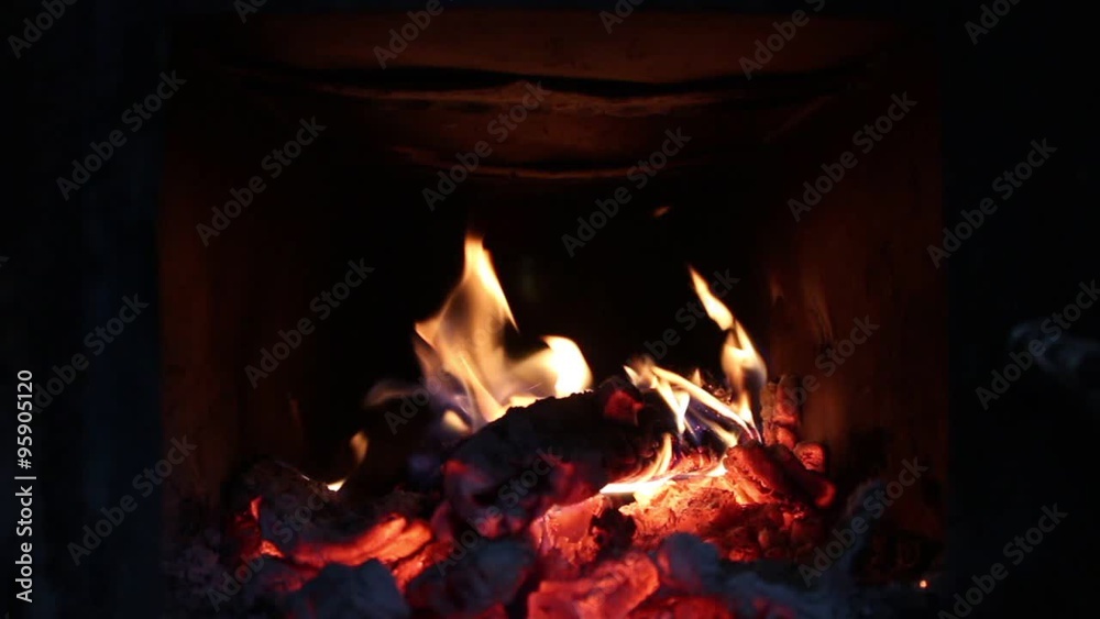 Burning fire inside of oven with dark background Burning fire inside of oven with dark background