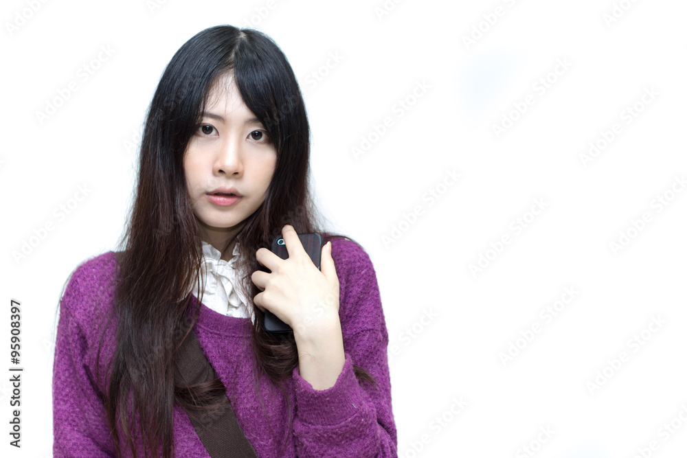 Asian girl in casual wear playing moblie phone Asian girl in casual wear playing moblie phone