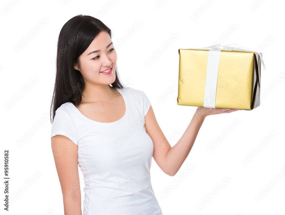 Young Woman looking at the gift box Young Woman looking at the gift box