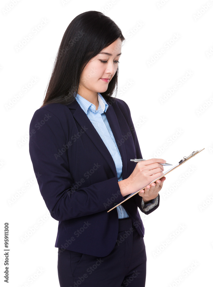 Asian Young Businesswoman take note on clipboard Asian Young Businesswoman take note on clipboard