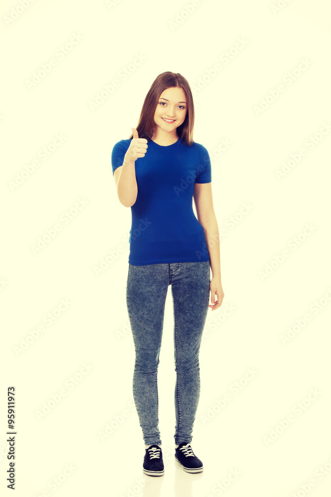 Happy female student showing thumbs up. Happy female student showing thumbs up.