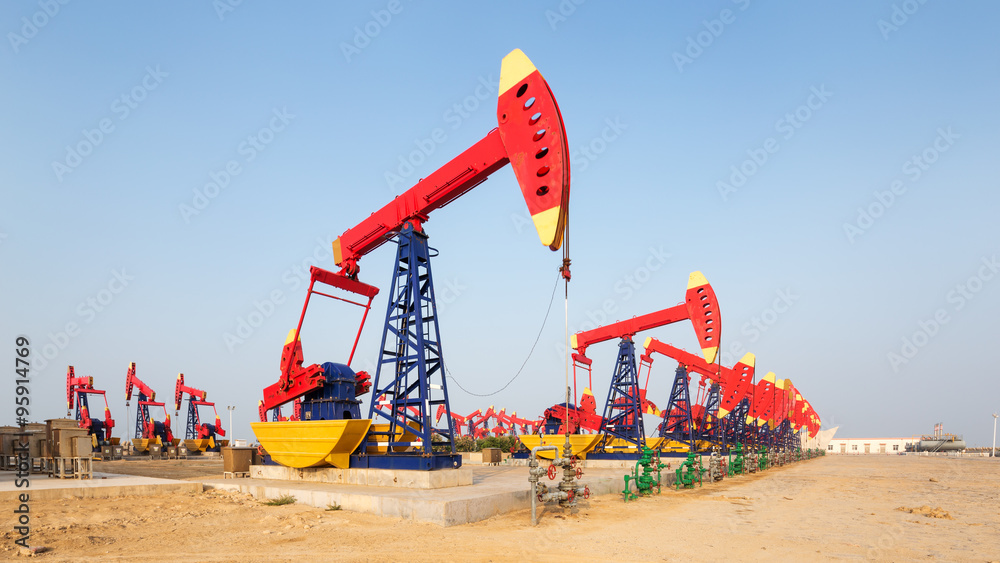 landscape of oilfield with pump units in blue sky landscape of oilfield with pump units in blue sky