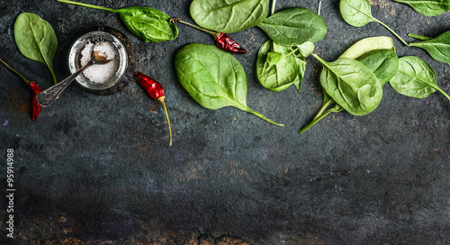 Schilderij op canvas Baby spinach leaves on rustic background, top view, banner