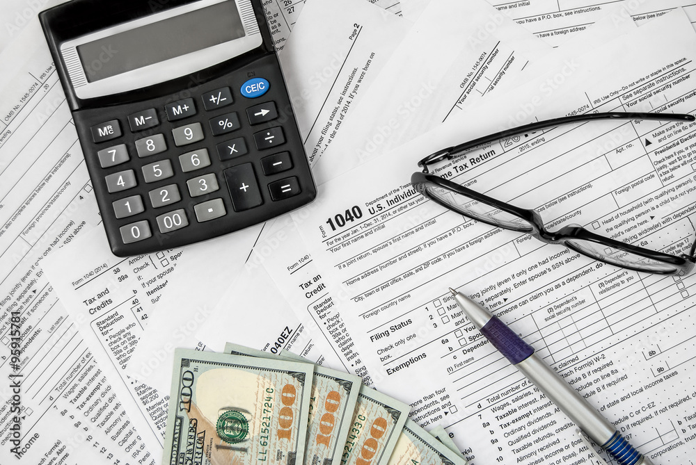 Tax form with pen, calculator, glasses and money Tax form with pen, calculator, glasses and money