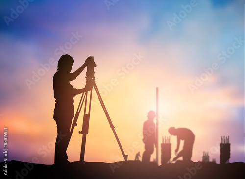 silhouette survey engineer working  in a building site over Blur