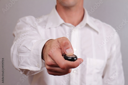Men's hand presses on the remote control car.Close up on man hands holding car key.