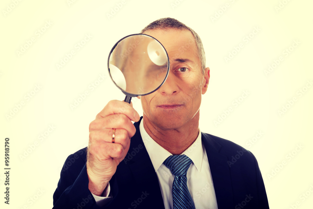 Portrait of businessman with a magnifying glass Portrait of businessman with a magnifying glass