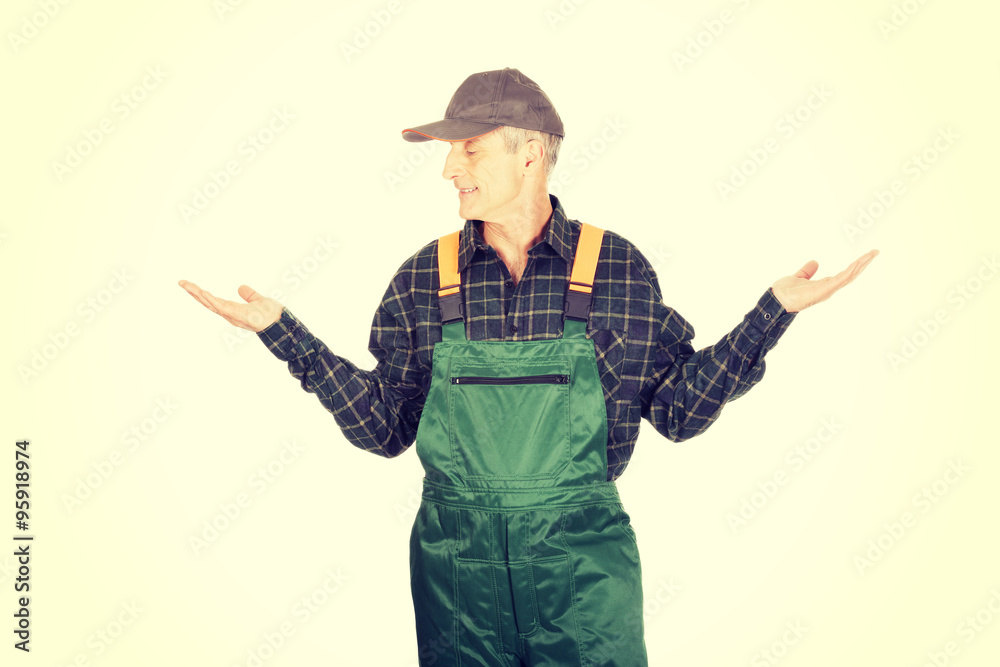 Gardener in uniform showing space with both hands Gardener in uniform showing space with both hands
