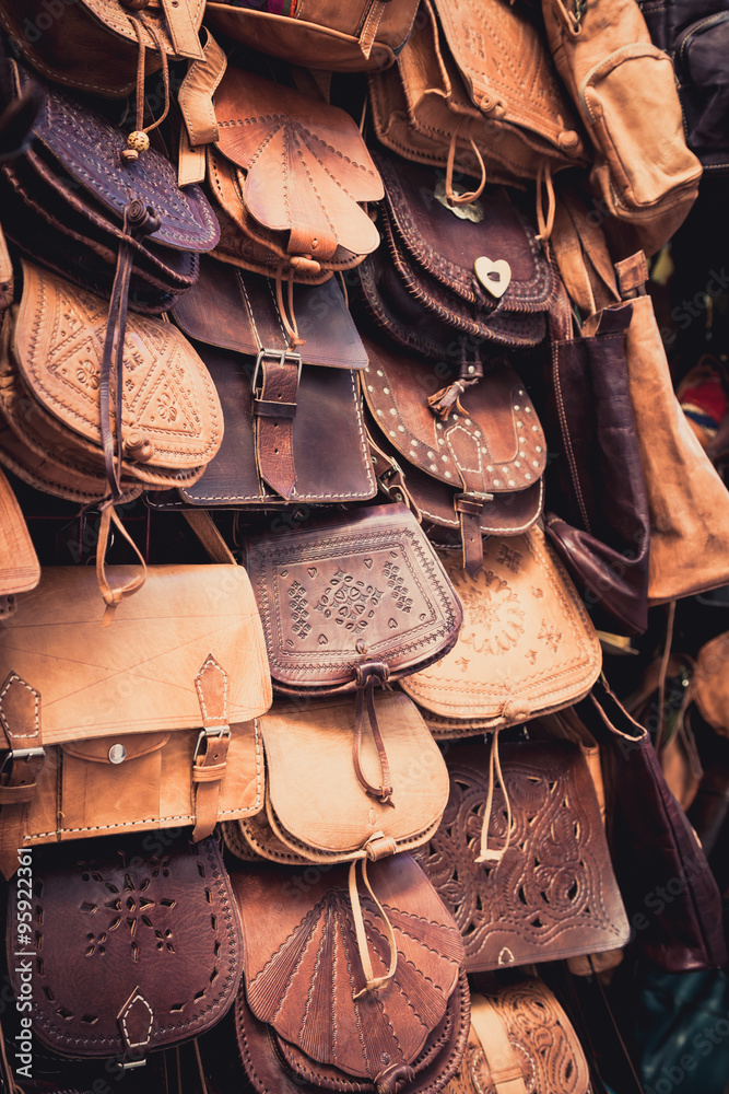 Moroccan leather goods bags in a row at outdoor market