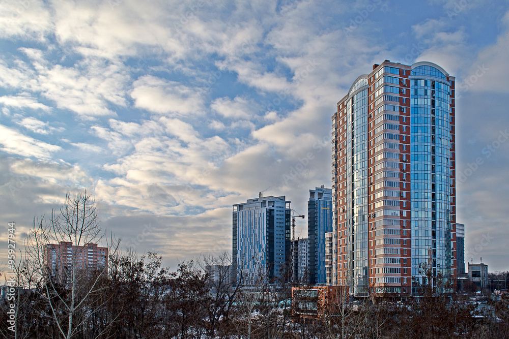 City landscape with modern buildings and blue sky with white clouds