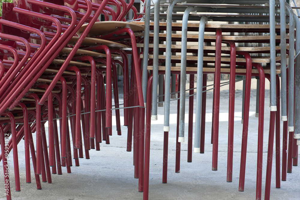stacked iron chairs and tables in the street stacked iron chairs and tables in the street