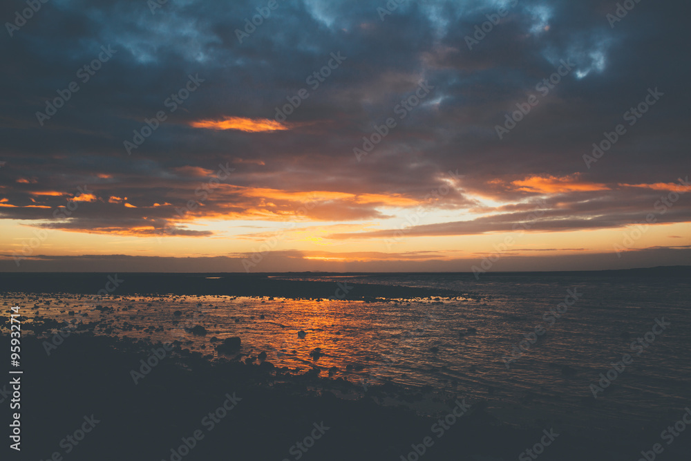 Sunset on beach in Iceland with beautiful clouds