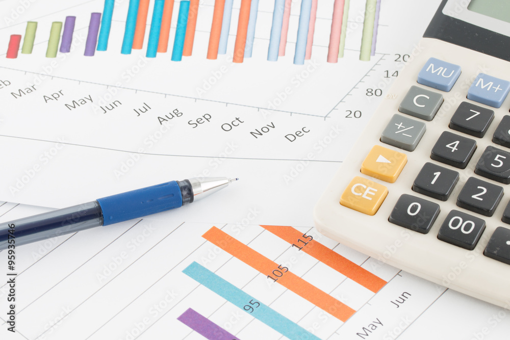 Business concept : Pen and calculator on graph background. Business concept : Pen and calculator on graph background.