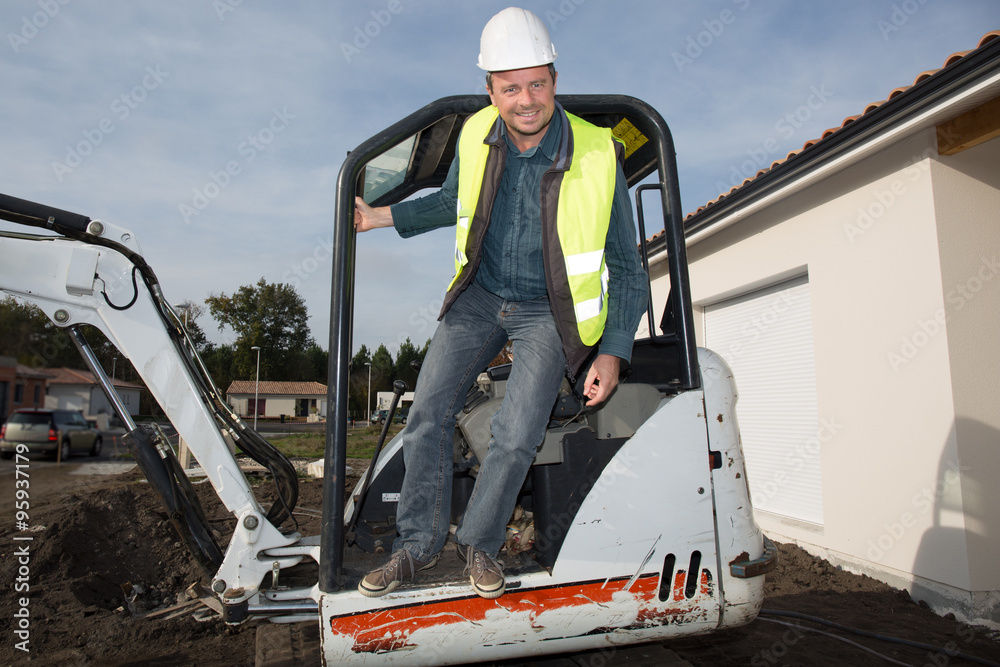 Crane operator at a construction site looking happy Crane operator at a construction site looking happy