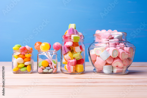Colorful candy in jar on table