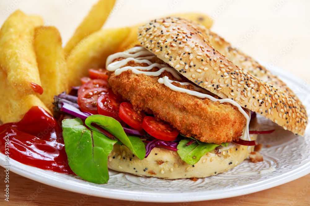 Home made Chicken burger with fried potatoes on old wooden table Home made Chicken burger with fried potatoes on old wooden table