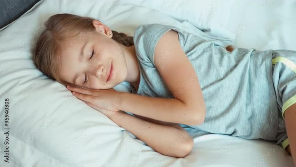 Girl is in a bed and wakes up and smiling Girl is in a bed and wakes up and smiling