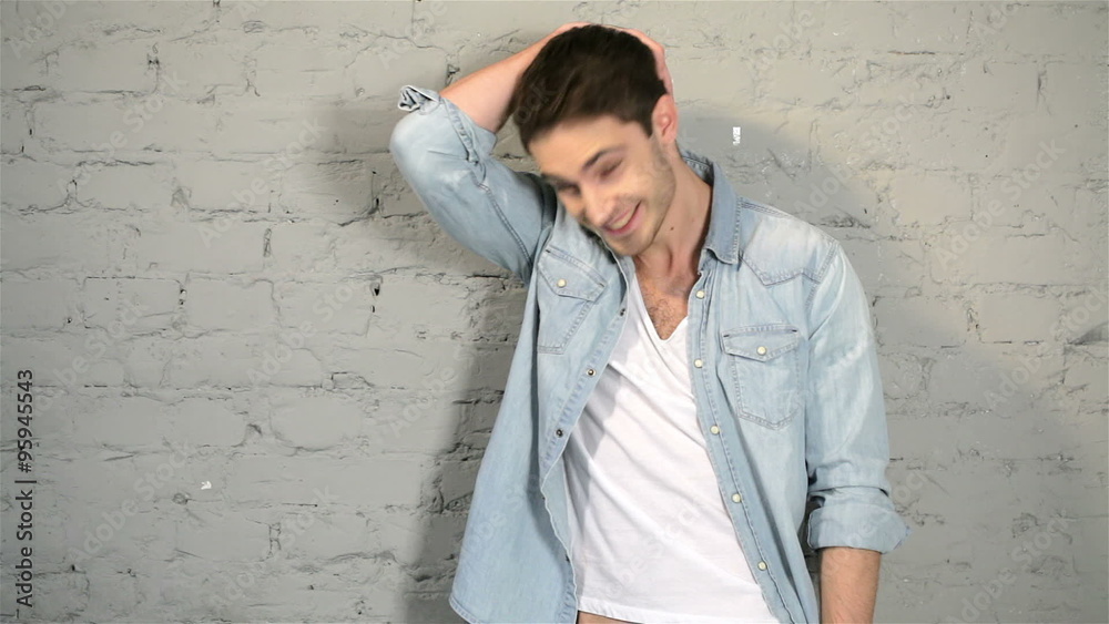 Male against a background of gray brick wall Male against a background of gray brick wall