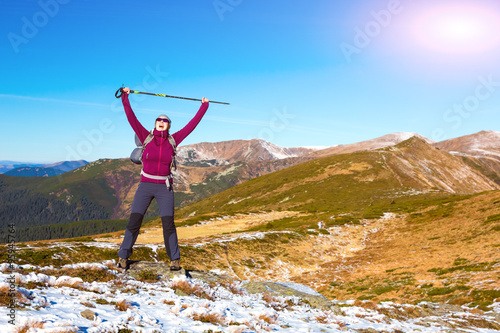 Happy Hiker with triumph arms raised in mountains landscape © alexbrylovhk