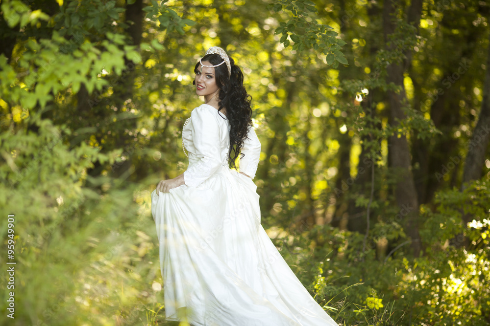 Wedding. Young beautiful bride with hairstyle and makeup posing in white dress Wedding. Young beautiful bride with hairstyle and makeup posing in white dress