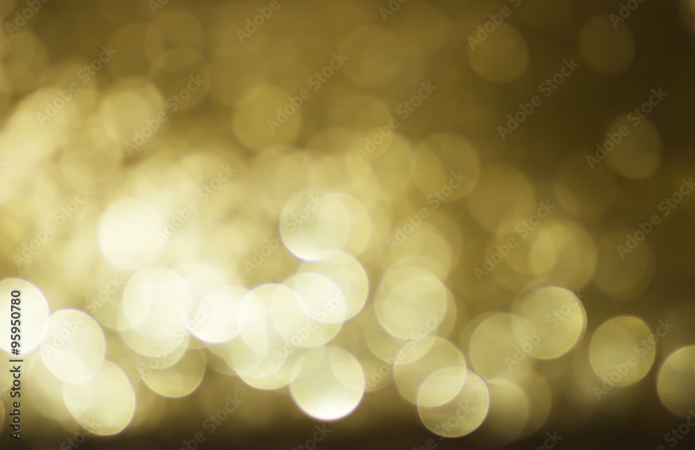 Obraz premium Blurred lights with bokeh effect golden Background. Soft and blur conception