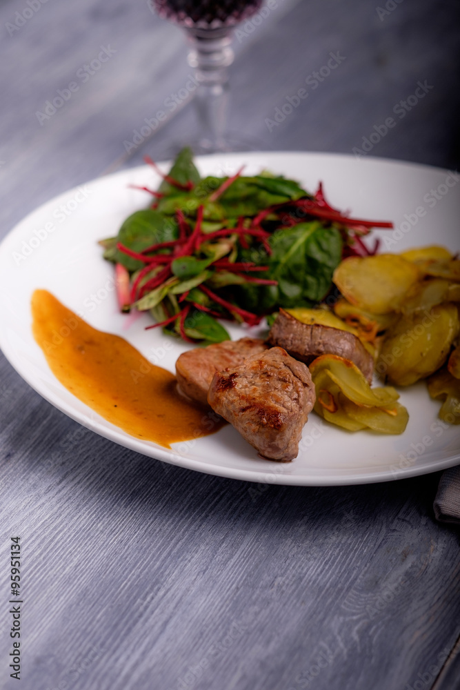 Veal steak with sauce and potatoes