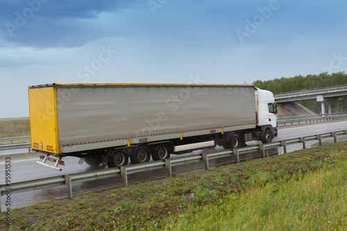 truck going on the highway to rain © Yuri Bizgaimer