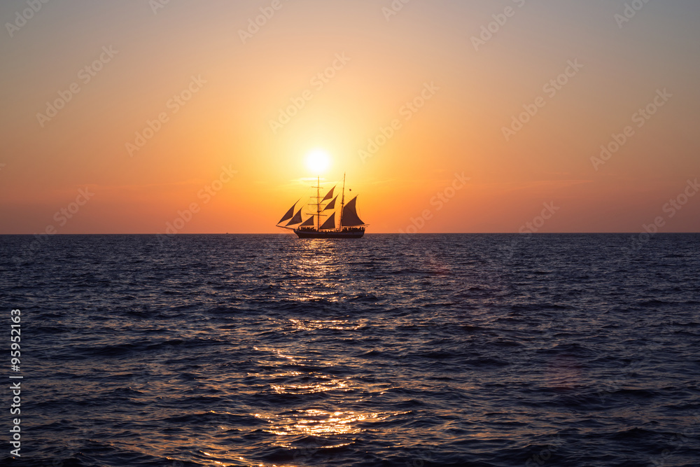 Ship in sea at sunset