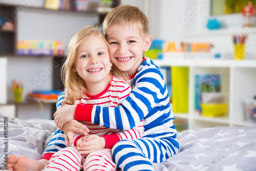 Cute little brother and sister in pajamas