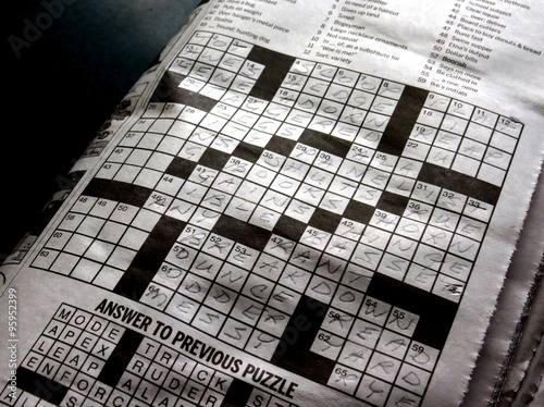 Solving the crossword puzzle in the newspaper.