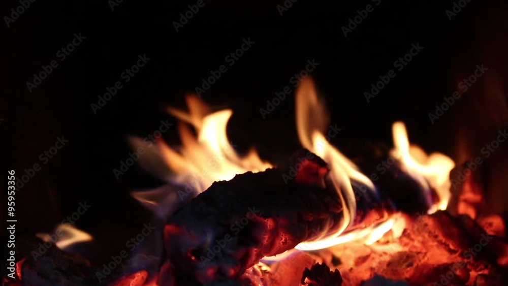 Burning fire inside of oven with dark background Burning fire inside of oven with dark background