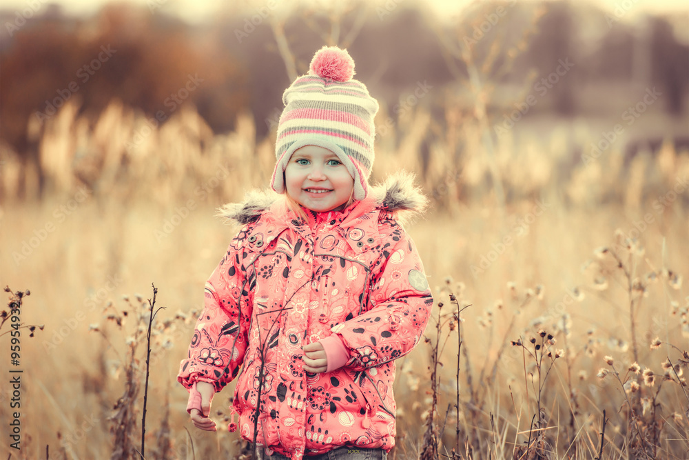 cute little girl in a field at sunset cute little girl in a field at sunset