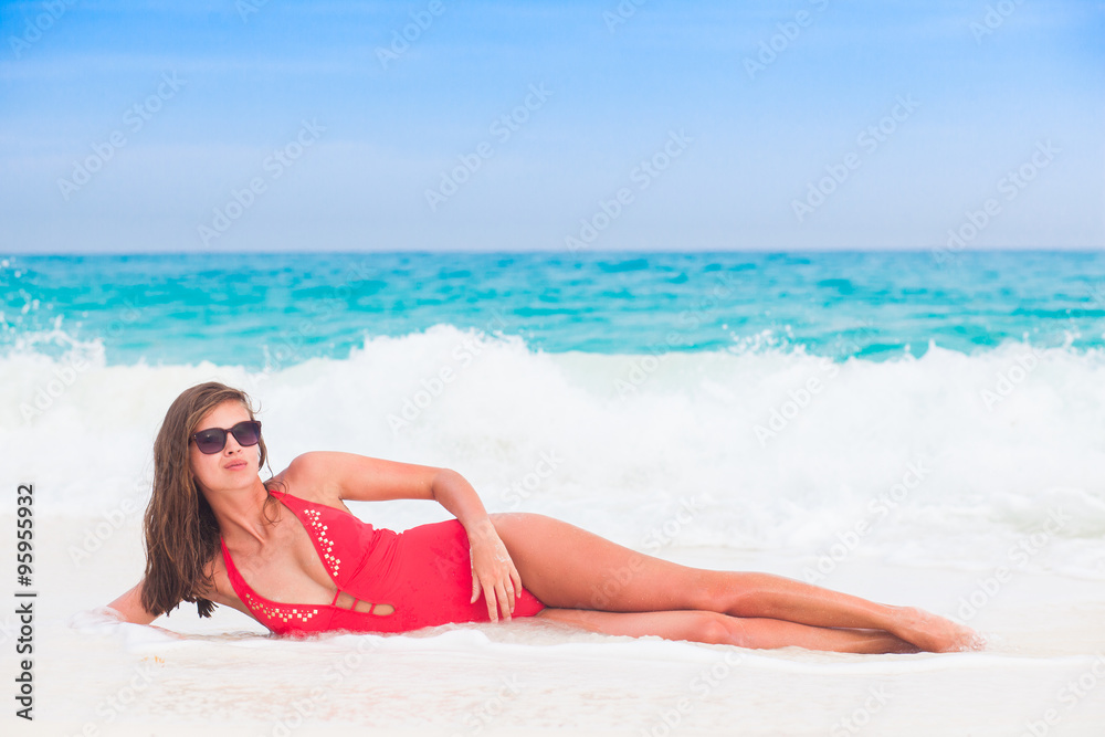 Young woman enjoying sunny day at tropical beach