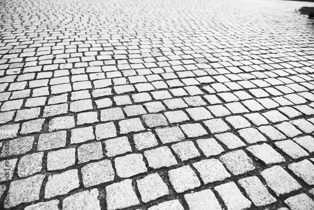Cobblestone pavement made of granite cubes in perspective
