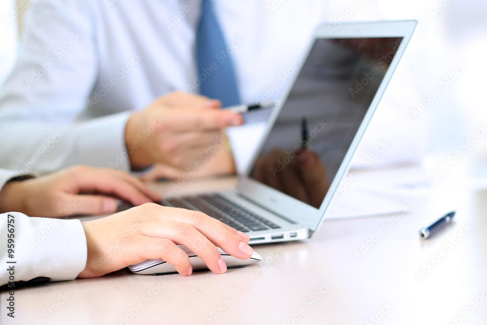 Business colleagues working and analyzing financial figures Business colleagues working and analyzing financial figures