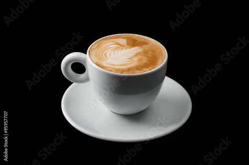 White cup of hot cappuccino on black background photo