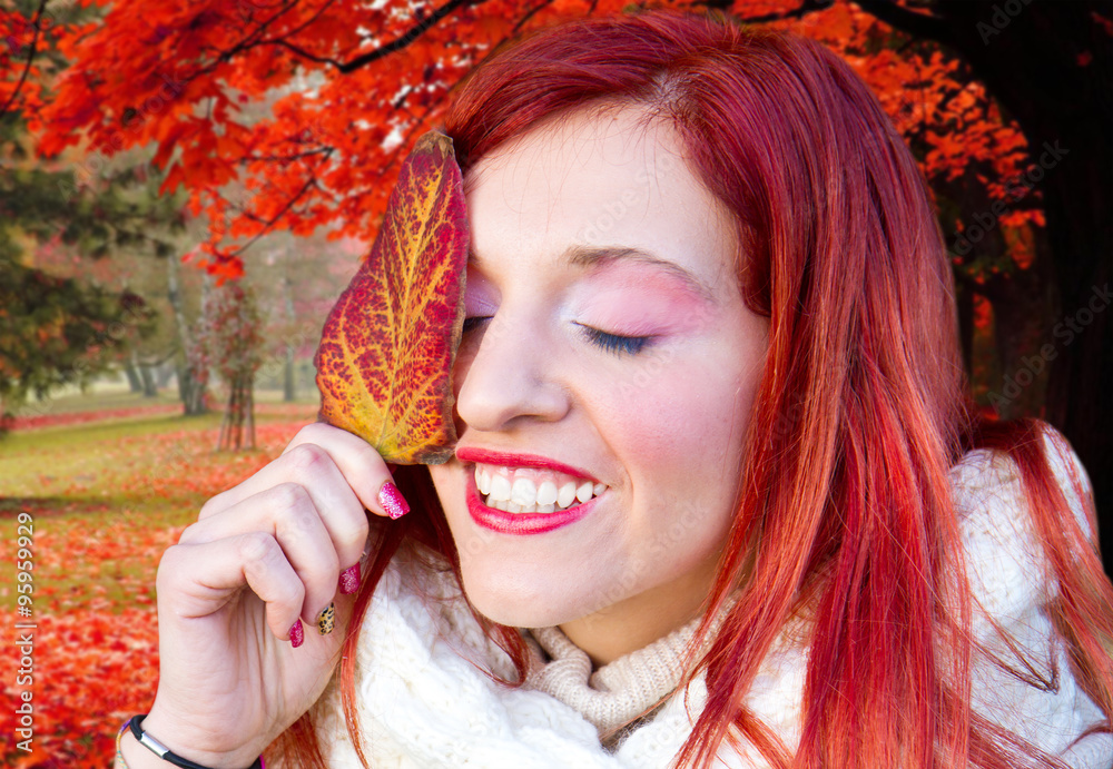 Portrait of cheerful young woman with autumn leafs in front of f Portrait of cheerful young woman with autumn leafs in front of f