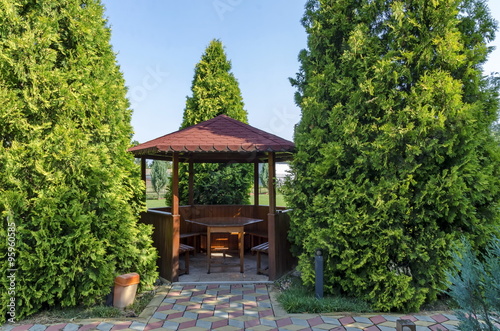 Fotografija Beauty green yard with alcove with table wooden and bench for rest, Septemvri to