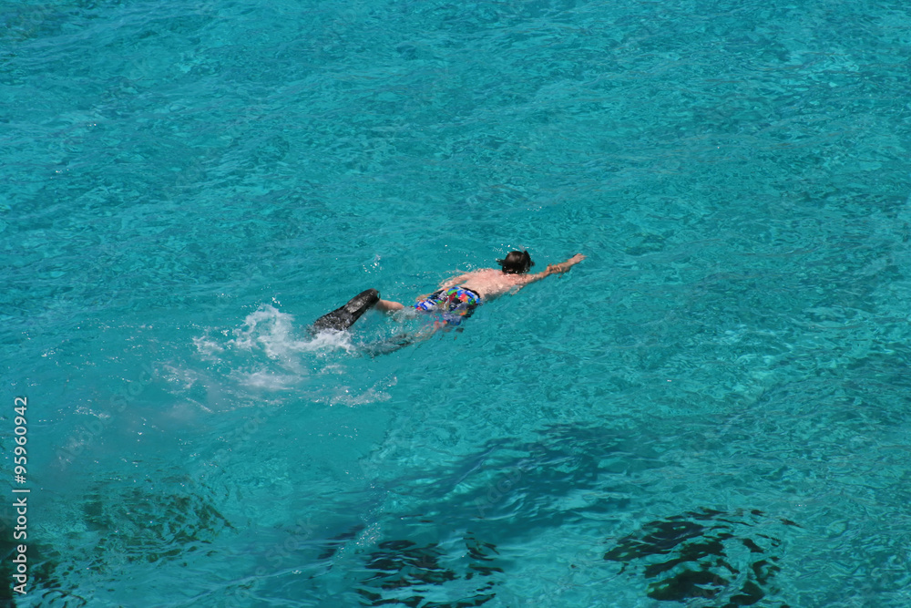 Young boy snorkeling in crystal clear water of Blue Lagoon (Comino,Malta).